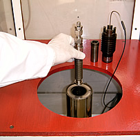 PvT Sample Cell being loaded into pressure vessel